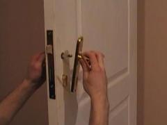 Installing a door handle with their hands